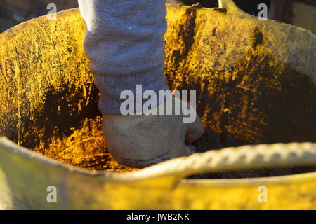 Brick layer holding a trowel with cement Stock Photo