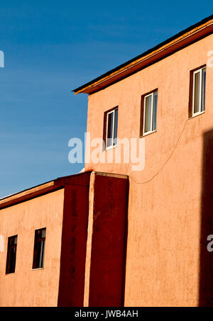 Yellow house. Old building. Old architecture. Blue and yellow. Stock Photo