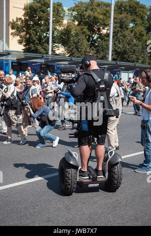 TALLINN, ESTONIA - 04 JUL 2014: Videographer shooting a reporting of ceremony using Segway Stock Photo