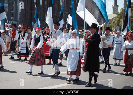 TALLINN, ESTONIA - 04 JUL 2014: People in Estonian costumes going at ceremonial procession of Estonian song and dance festival Stock Photo