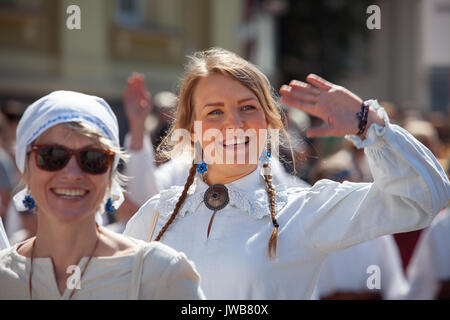 TALLINN, ESTONIA - 04 JUL 2014: Young woman smiling at ceremonial procession of Estonian song and dance festival Stock Photo