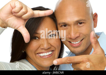 Asian couple making picture hand gestures isolated on white. Stock Photo