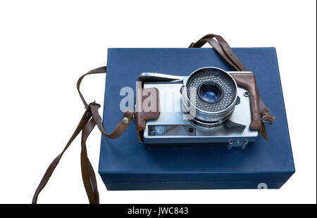 vintage film photo camera in leather case on a blue box isolated cutout on white background. high angle shot Stock Photo