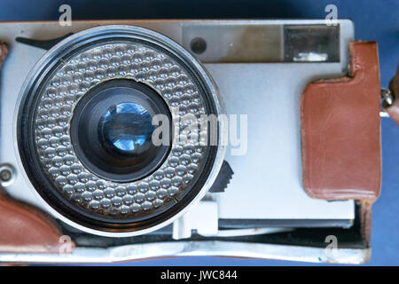 closeup of vintage film still camera with lens attached in leather case Stock Photo