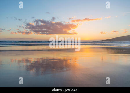 Reflection, sunset over the sea, Sandfly Bay, Dunedin, Otago, South Island, New Zealand Stock Photo