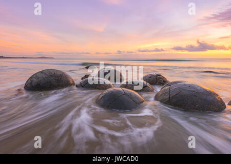 Moeraki boulders, at sunrise, geological formation, Koekohe Beach, Moeraki, East Coast, Otago, South Island, New Zealand Stock Photo