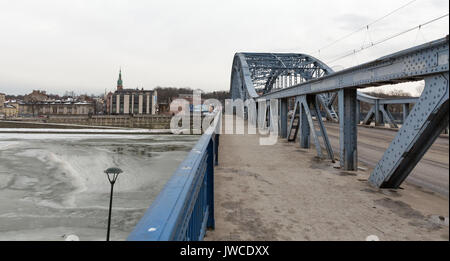 KRAKOW, POLAND - JANUARY 13, 2017: Winter cityscape with frozen Vistula river and Marshal Jozef Pilsudski bridge. Vistula is the longest and largest r Stock Photo