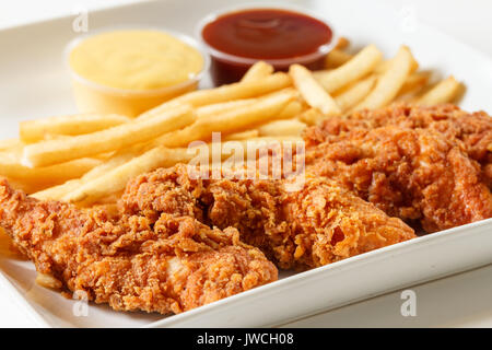 fried chicken fingers with french fries and dipping sauce Stock Photo