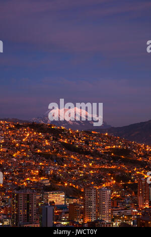 Last light on Illimani (6438m/21,122ft), and lights of La Paz, Bolivia, South America Stock Photo