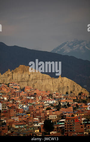 Brick houses, eroded hill and Illimani (6438m/21,122ft), La Paz, Bolivia, South America Stock Photo