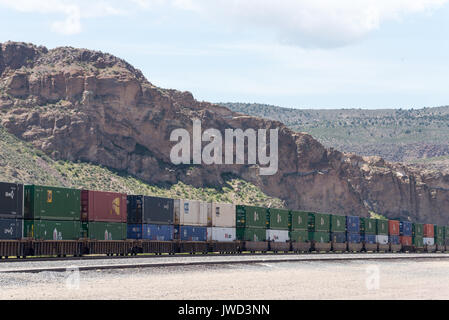 Double stacked intermodal containers on a freight train in Caliente, NV. Stock Photo