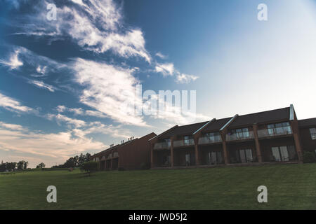 Hotel buildings under blue skies with vineyard in foreground Stock Photo