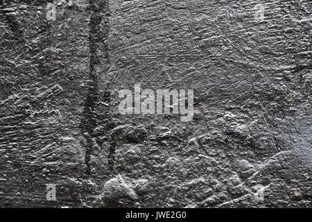 The texture of the paint is metallic in color with a touch of silver on the old wall which is cracked from time to time. Stock Photo