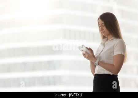 Confident successful businesswoman holding using digital tablet  Stock Photo