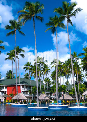 Punta Cana, Dominican republic - February 04, 2013: Ordinary tourists resting in Barcelo Bavaro Beach hotel with pool under palms Stock Photo