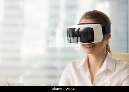 Happy woman wearing VR goggles, getting virtual ar reality exper Stock Photo