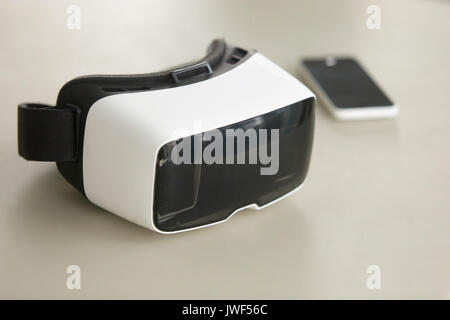 VR headset and smartphone on desk, virtual reality mobile techno Stock Photo