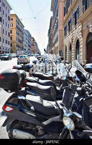 Parked scooters and motorcycles on the city street Stock Photo