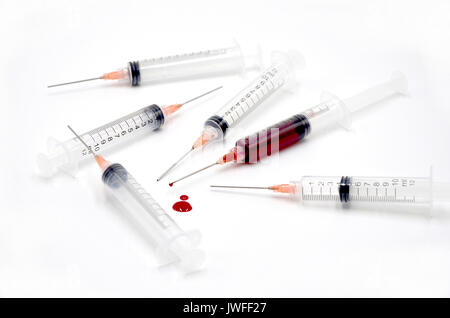 Syringe with blood on white background Stock Photo