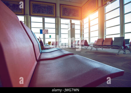 Waiting chairs zone in airport. Vintage tone. Stock Photo