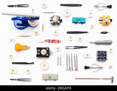watchmaker workshop - ornament from various watch repairing tools on white background Stock Photo