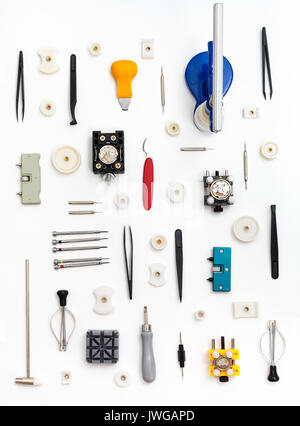 watchmaker workshop - vertical pattern from various watch repairing tools on white background Stock Photo