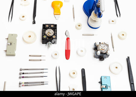 watchmaker workshop - collage of various tools for watch repairing on white background Stock Photo