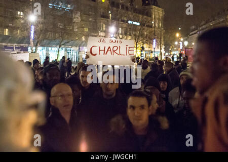Sign je suis charlie standing out of the crowd. Homage at the victims of Charlie hebdo killing in Paris the 7th of january 2015. Stock Photo