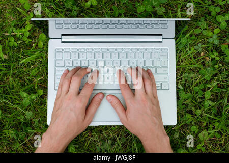 Close-up of male hand typing on laptop. Stock Photo