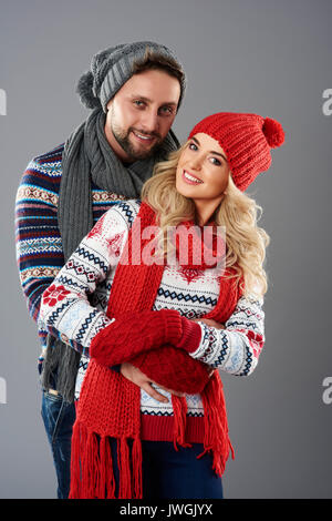 Cute couple in warm clothing smiling at camera Stock Photo - Alamy