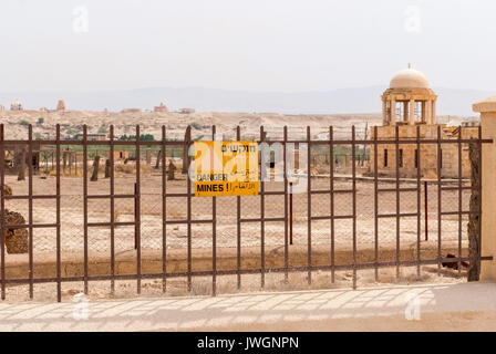 Minefield sign in Hebrew, Arabic, English in Jordan valley, Israel Stock Photo