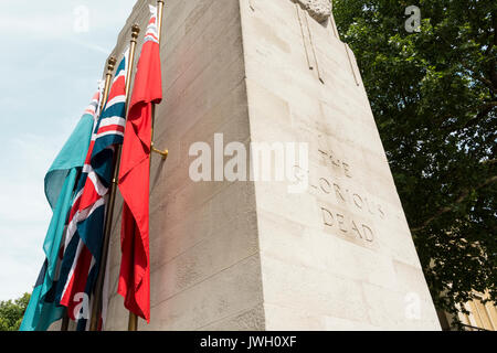 Flags flanking the sides of The Cenotaph representing the Royal Navy, the British Army, the Royal Air Force, and the Merchant Navy. Stock Photo