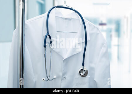 job vacancy - white doctor coat on hanger in hospital hallway Stock Photo