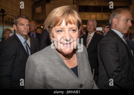Dortmund, Germany. 12th Aug, 2017. German Chancellor Angela Merkel leaves after attending an election rally for Germany's federal election in Dortmund, Germany, on Aug. 12, 2017. Credit: Joachim Bywaletz/Xinhua/Alamy Live News Stock Photo