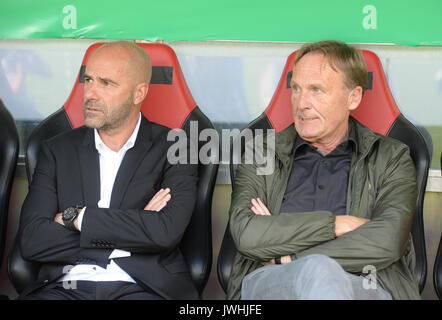 Dortmund's manager Peter Bosz (L) and CEO Hans-Joachim Watzke sit on the bench ahead of the German Soccer Association (DFB) Cup first-round soccer match between 1. FC Rielasingen-Arlen and Borussia Dortmund in the Schwarzwald Stadium in Freiburg, Germany, 12 August 2017. The club has announced that Ousmane Dembele, the young attacking midfielder whose breakout season at the club has led to him being linked with clubs across Europe including Barcelona, will remain suspended from the team 'until further notice'. The announcement was made on Sunday morning at a conference with Dortmund's sports d Stock Photo