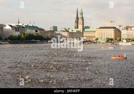 Hamburg, Germany. 13th Aug, 2017. dpatop - Ironman competitors swim in the Inner Alster Lake in Hamburg, Germany, 13 August 2017. Around 2500 athletes will swim 3.8 kilometres in the Alster, cycle 180 kilometres through Lower Saxony and Hamburg and run a 42 kilometre marathon round the Alster lakes. Photo: Daniel Bockwoldt/dpa/Alamy Live News Stock Photo