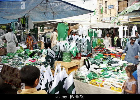 Islamabad, Pakistan. 13th Aug, 2017. People buy souvenirs at a market on the eve of Pakistan's Independence Day in Islamabad, capital of Pakistan, Aug. 13, 2017. Pakistan will celebrate Independence Day on Aug. 14. Credit: Saadia Seher/Xinhua/Alamy Live News Stock Photo