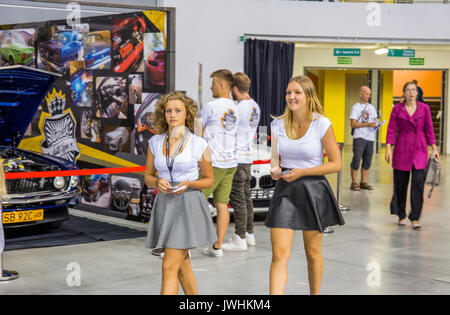 Bielsko-Biala, Poland. 12th Aug, 2017. International automotive trade fairs - MotoShow Bielsko-Biala. Girls walking through the hall with leaflets in hands. Credit: Lukasz Obermann/Alamy Live News Stock Photo