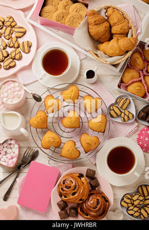 Flat lay cakes and cookies, muffins and rolls, biscuits and sweets, tea and coffee with marshmallow. Top view. Stock Photo