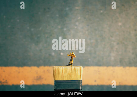 Giraffe inside a paintbrush on the Street Stock Photo