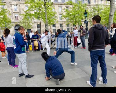 Group at Place de la République, Paris, France, giving a demonstration of Capoeira, a Brazilian martial art that combines dance, music, and acrobatics. Stock Photo