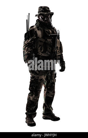 Special forces United States in Camouflage Uniforms studio shot. Holding weapons, wearing jungle hat, Shemagh scarf, painted face, his outfit clothes  Stock Photo