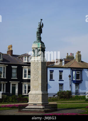 WW1 WW2 War Memorial  statue in the form of a Bronze angel or winged messenger flanked by Victorian Terrace Houses Stock Photo