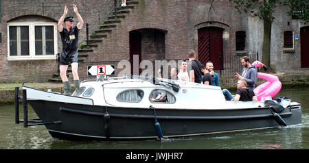 A boat carrying a stag party sails on a canal in Utrecht, the Netherlands, August 5, 2017. © John Voos Stock Photo