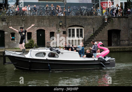 A boat carrying a stag party sails on a canal in Utrecht, the Netherlands, August 5, 2017. © John Voos Stock Photo