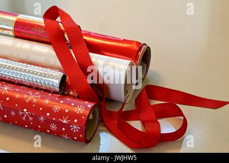 rolls of red and silver Christmas gift wrap with ribbon Stock Photo