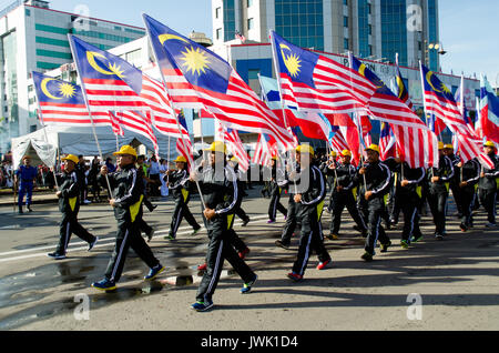 Kota KInabalu, Malaysia - August 31, 2016: Participants waving a Malaysian flags during Malaysia's  59th Independence Day parade held in Kota Kinabalu Stock Photo