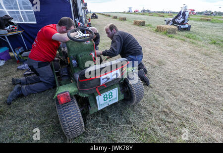 Adjustments are made to a lawnmower during qualifying for the British Lawn Mower Racing Association 12 hour endurance race at Five Oaks near to Billingshurst in West Sussex. Stock Photo