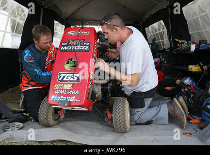 Adjustments are made to a lawnmower after qualifying for the British Lawn Mower Racing Association 12 hour endurance race at Five Oaks near to Billingshurst in West Sussex. Stock Photo