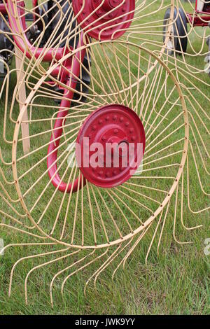 Vintage hay tedder attached to tractor at an agricultural show in Devon. Stock Photo